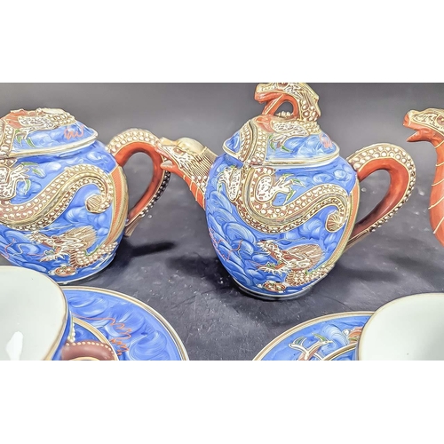 586 - A Blue Porcelain Japanese ''Dragonware'' Tea Service with Geisha girl to base of cups. Comprises two... 