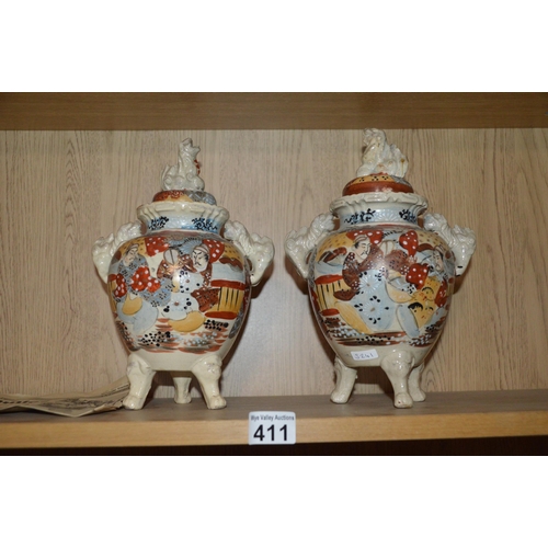 411 - pair of Oriental pottery urns, some damage to lids