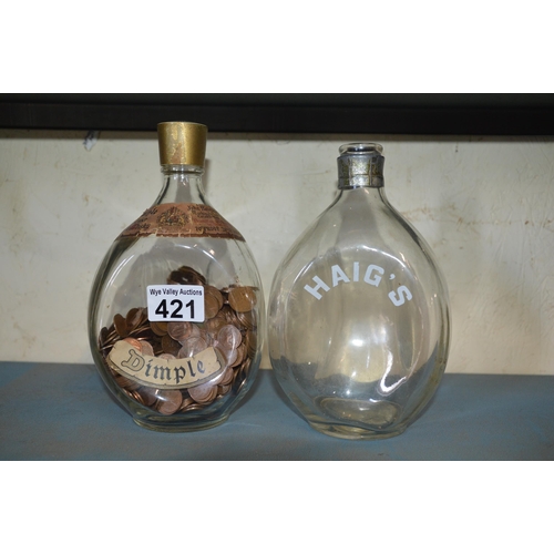 421 - whiskey bottles with coins in