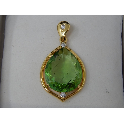 31 - Large Peridot & Diamond Pendant. Pear shaped Peridot weighing 23.82cts with a round brilliant cut di... 