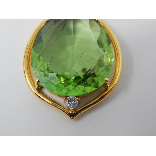 31 - Large Peridot & Diamond Pendant. Pear shaped Peridot weighing 23.82cts with a round brilliant cut di... 