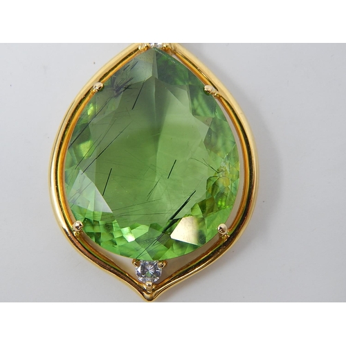 31 - Large Peridot & Diamond Pendant. Pear shaped Peridot weighing 23.82cts with a round brilliant cut di... 