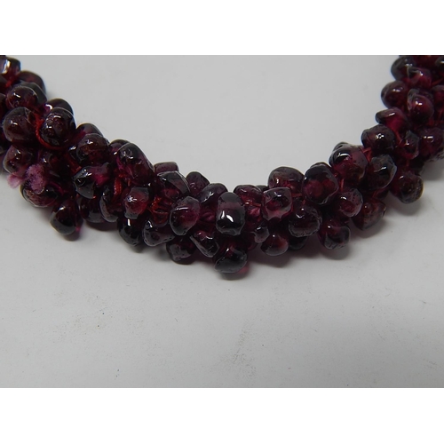 37 - Garnet Bead Necklace, length 70cm together with a Garnet Bead Bangle a/f.