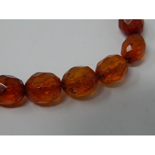 40 - Amber Necklace with graduating faceted beads, length 57cm together with a pair of Amber drop earring... 