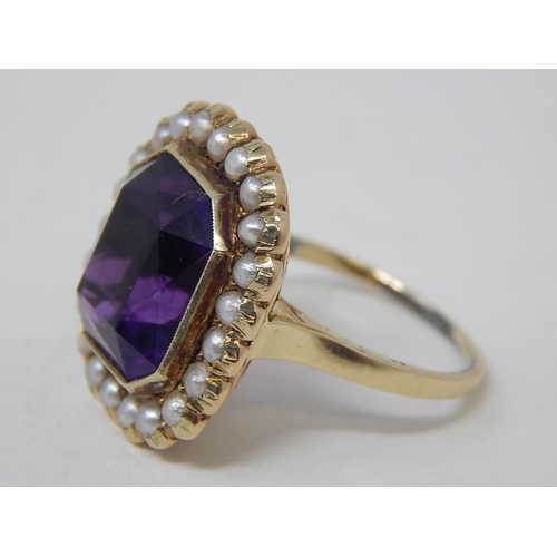 67 - Gold Ring, set Amethyst with seed pearl border. Size N