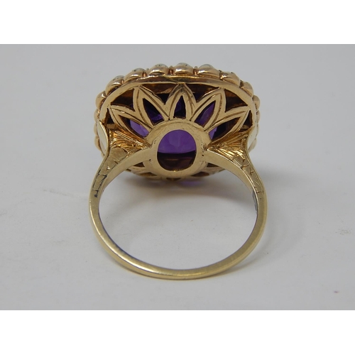 67 - Gold Ring, set Amethyst with seed pearl border. Size N