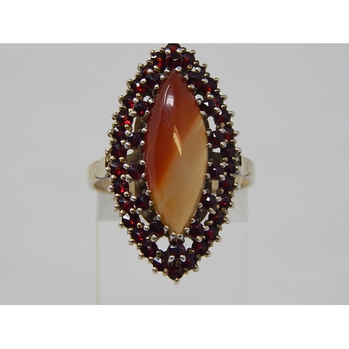 69 - Silver Gilt Ring, set central Agate with a Garnet Border. Ring size Q 1/2.