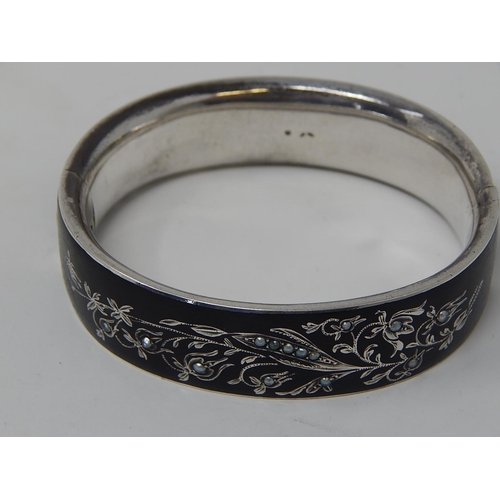 76 - A Silver Black Enamelled & Seed Pearl Mourning Bangle.