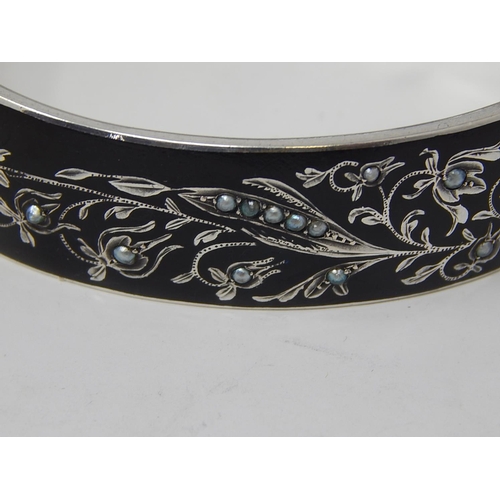 76 - A Silver Black Enamelled & Seed Pearl Mourning Bangle.