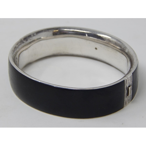 76 - A Silver Black Enamelled & Seed Pearl Mourning Bangle.