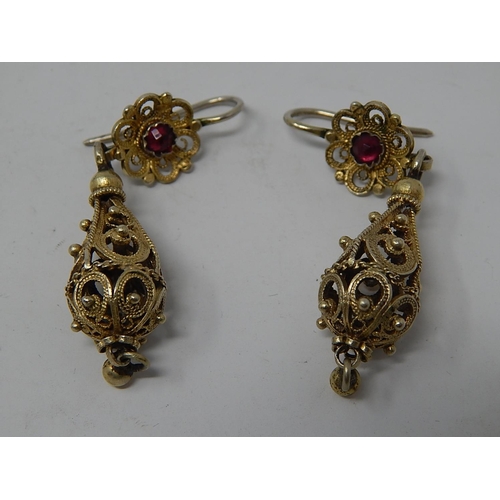 87 - A Pair of Eastern European Silver Gilt Earrings Set with a Garnet.