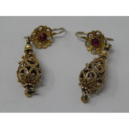 87 - A Pair of Eastern European Silver Gilt Earrings Set with a Garnet.