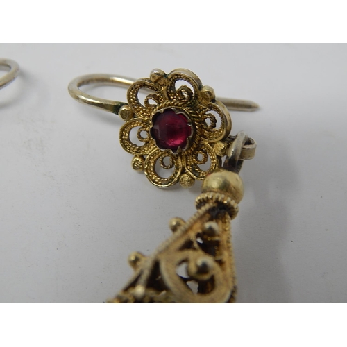 87 - A Pair of Eastern European Silver Gilt Earrings Set with a Garnet.