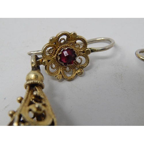 87 - A Pair of Eastern European Silver Gilt Earrings Set with a Garnet.