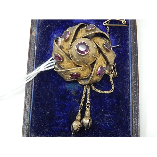 96 - Victorian yellow metal Brooch / Locket, set 7 Amethysts, with safety chain. weight 12.21g gross.