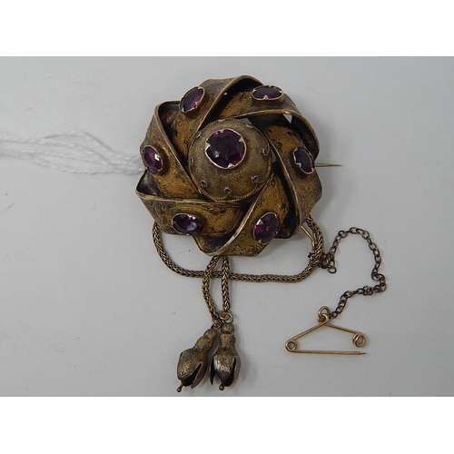 96 - Victorian yellow metal Brooch / Locket, set 7 Amethysts, with safety chain. weight 12.21g gross.