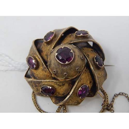 96 - Victorian yellow metal Brooch / Locket, set 7 Amethysts, with safety chain. weight 12.21g gross.