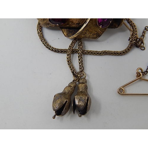 96 - Victorian yellow metal Brooch / Locket, set 7 Amethysts, with safety chain. weight 12.21g gross.