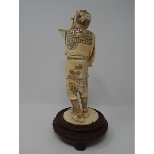 842 - Meiji (1868-1912) Japanese Ivory Figure, Signed to Base on Wooden Stand. The Figure 20.5cm High