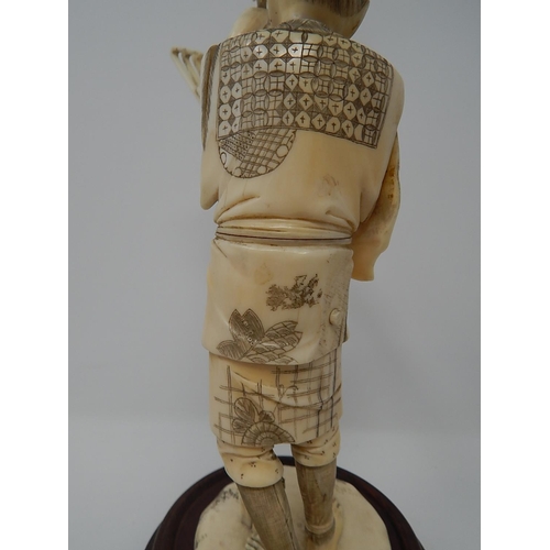 842 - Meiji (1868-1912) Japanese Ivory Figure, Signed to Base on Wooden Stand. The Figure 20.5cm High