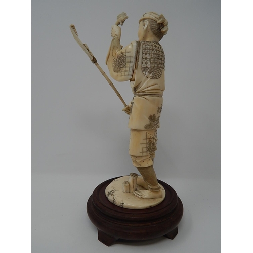 842 - Meiji (1868-1912) Japanese Ivory Figure, Signed to Base on Wooden Stand. The Figure 20.5cm High