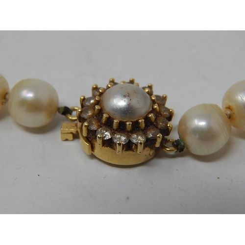 102 - Pearl Necklace With an 18ct Gold Clasp set with a central pearl & Diamond border. Length 40cm.