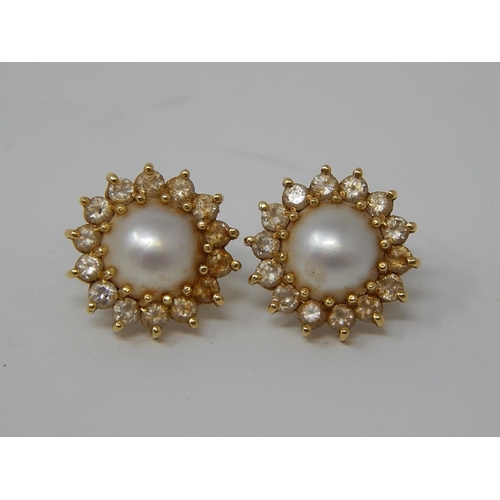 103 - Pearl Earrings Set in 18ct Gold with Diamond Borders.