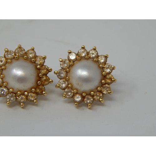 103 - Pearl Earrings Set in 18ct Gold with Diamond Borders.