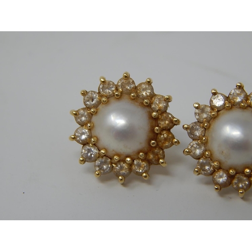 103 - Pearl Earrings Set in 18ct Gold with Diamond Borders.