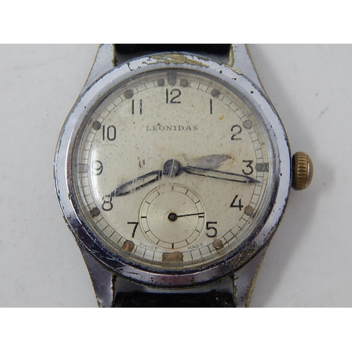 222 - Military: Gents Leonidas wristwatch, marked with broad arrow to back on leather strap.