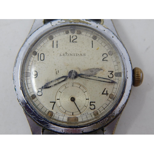 222 - Military: Gents Leonidas wristwatch, marked with broad arrow to back on leather strap.