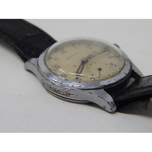 222 - Military: Gents Leonidas wristwatch, marked with broad arrow to back on leather strap.