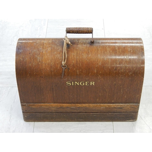 827 - Singer Sewing Machine within its original fitted wooden case complete with key.