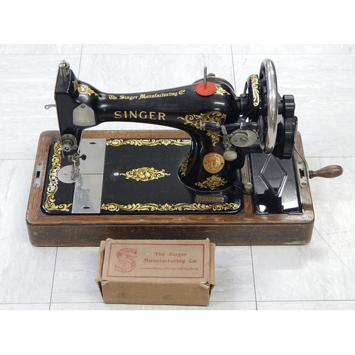 827 - Singer Sewing Machine within its original fitted wooden case complete with key.