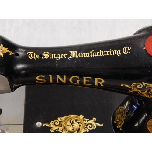 827 - Singer Sewing Machine within its original fitted wooden case complete with key.