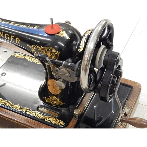 827 - Singer Sewing Machine within its original fitted wooden case complete with key.