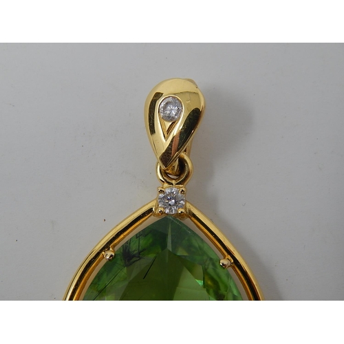 26 - Large Peridot & Diamond Pendant. Pear shaped Peridot weighing 23.82cts with a round brilliant cut di... 