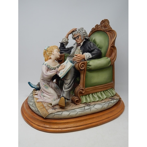 358 - Large Capodimonte Figural Group of a Child Reading to Her Father on Wooden Stand. Measures 42cm wide... 