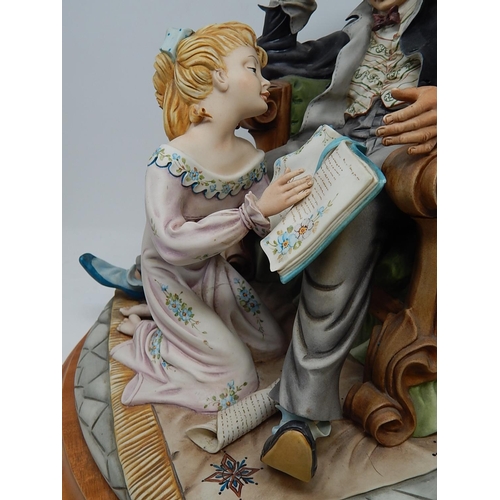 358 - Large Capodimonte Figural Group of a Child Reading to Her Father on Wooden Stand. Measures 42cm wide... 