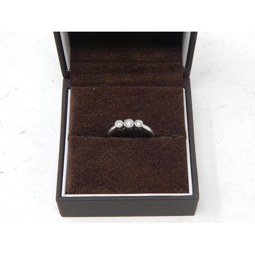 57 - 9ct white gold three stone diamond ring 0.25ct, size O.