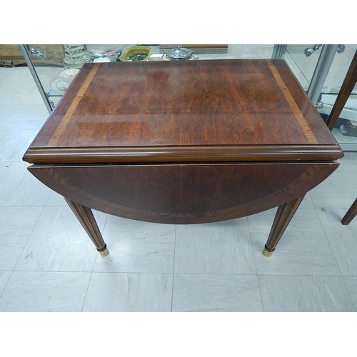 831 - Inlaid Mahogany drop flap table on brass feet. Measures 72cm wide x 55cm (111cm extended) x 55cm hig... 