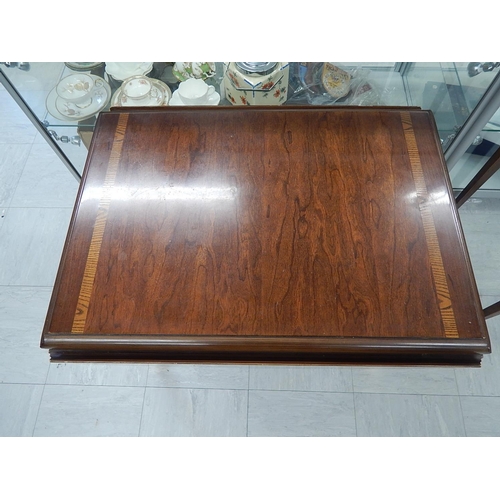 831 - Inlaid Mahogany drop flap table on brass feet. Measures 72cm wide x 55cm (111cm extended) x 55cm hig... 