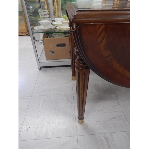 831 - Inlaid Mahogany drop flap table on brass feet. Measures 72cm wide x 55cm (111cm extended) x 55cm hig... 