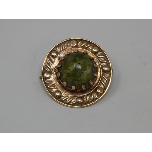 76 - 9ct Gold Arts & Crafts Style Brooch with Spinach Jade Cabochon. Diameter 2.5cm