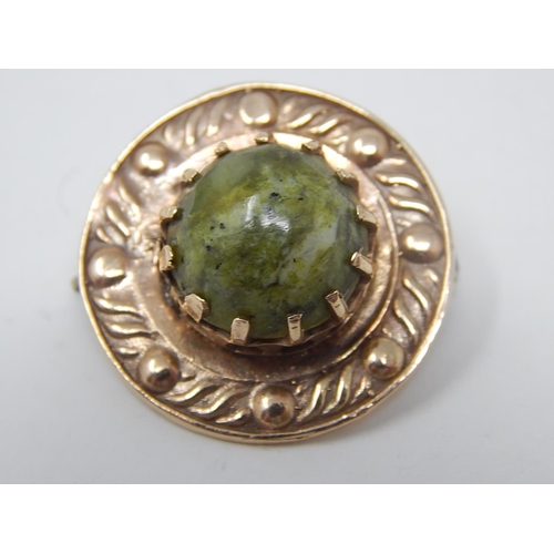 76 - 9ct Gold Arts & Crafts Style Brooch with Spinach Jade Cabochon. Diameter 2.5cm