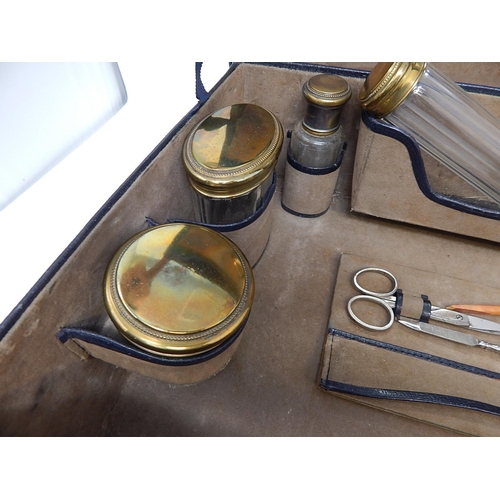 1 - Vanity Set Contained within Fitted Dark Blue Case comprising Five Gilded Topped Glass Jars, Mirror, ... 