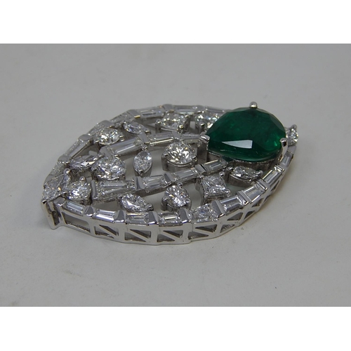 100 - Emerald and diamond pendant, marquise shaped openwork pendant set with a pear cut emerald at the bot... 