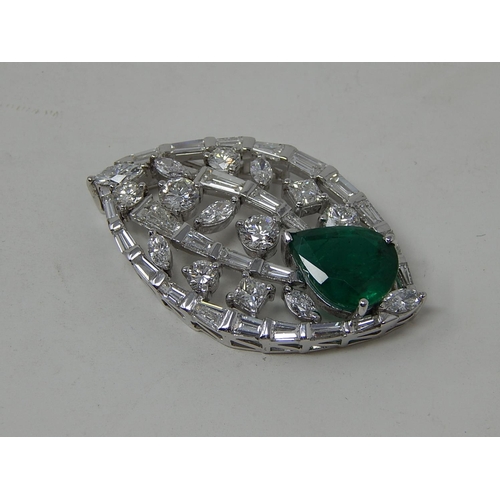 100 - Emerald and diamond pendant, marquise shaped openwork pendant set with a pear cut emerald at the bot... 