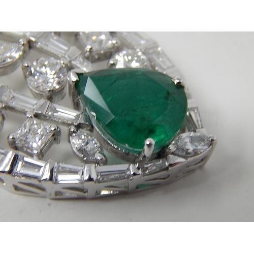 100 - Emerald and diamond pendant, marquise shaped openwork pendant set with a pear cut emerald at the bot... 