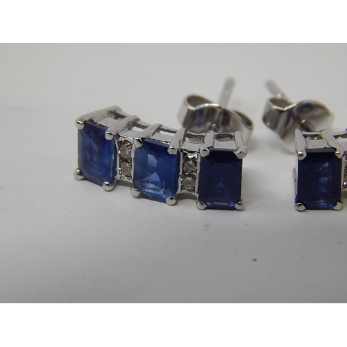 104 - Sapphire and diamond earrings, three rectangular cut sapphires vertically set with two round brillia... 